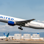 United Airlines Boeing 777-200 departs on a flight, representing the airline’s Starlink-equipped transatlantic service.