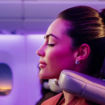 Passenger using Emirates' U-Dream headrest for enhanced Economy Class comfort.