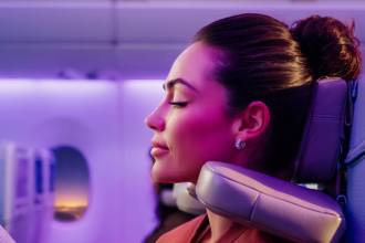 Passenger using Emirates' U-Dream headrest for enhanced Economy Class comfort.