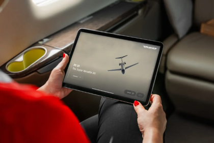Passenger using the Pilatus PC-24 touchscreen inflight entertainment system.