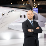 Dassault Aviation executive standing beside a Falcon 6X