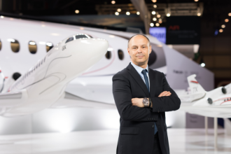 Dassault Aviation executive standing beside a Falcon 6X