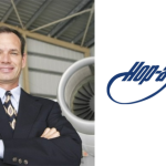 Barry Ellis of Hop-A-Jet standing beside a private jet
