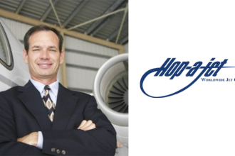 Barry Ellis of Hop-A-Jet standing beside a private jet