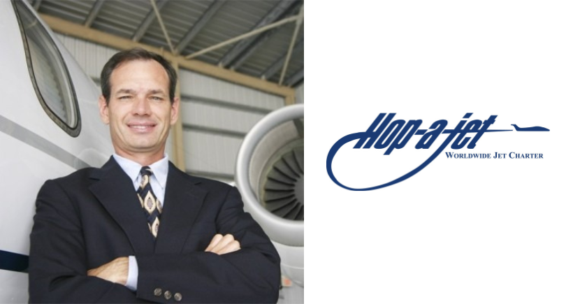 Barry Ellis of Hop-A-Jet standing beside a private jet
