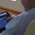 Business aircraft passenger using tablet during flight