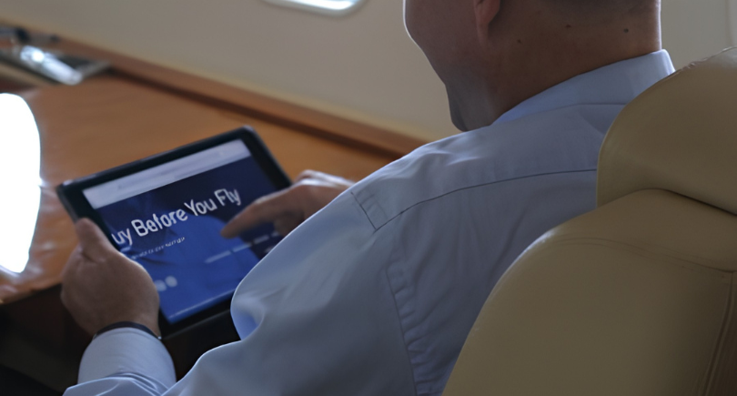 Business aircraft passenger using tablet during flight