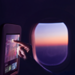 Passenger using Panasonic Avionics’ OLED in-flight entertainment screen.