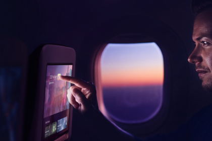 Passenger using Panasonic Avionics’ OLED in-flight entertainment screen.