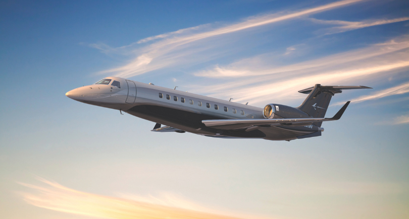 Embraer Legacy 650 business jet flying above clouds