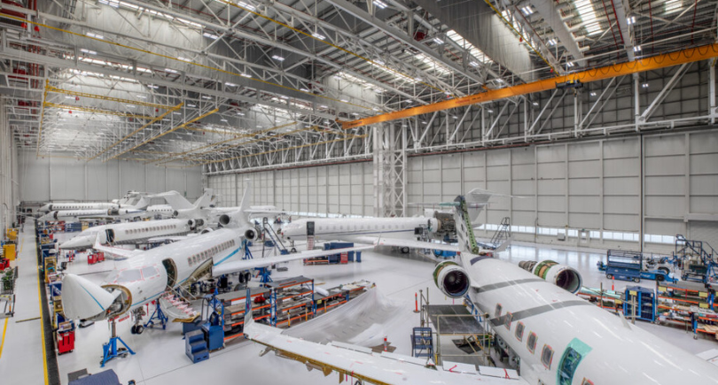 ExecuJet MRO facility with multiple business jets undergoing maintenance.