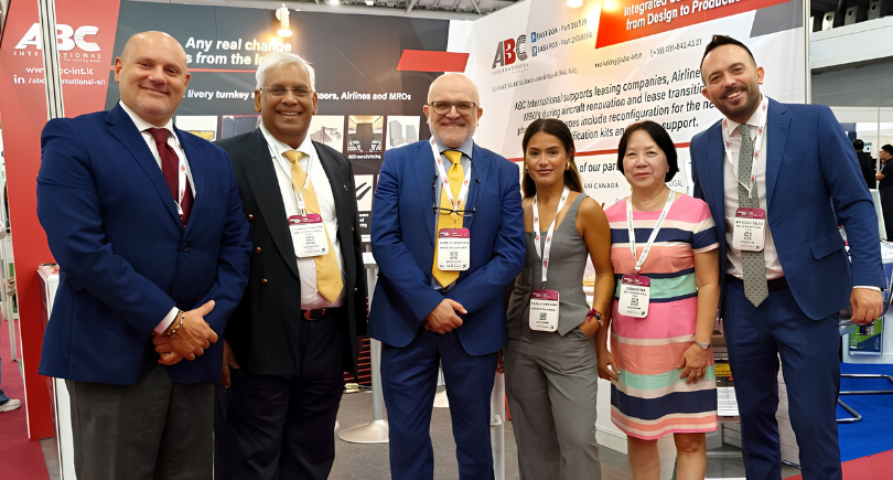 ABC International and JSD Corporation representatives at an aviation industry event.